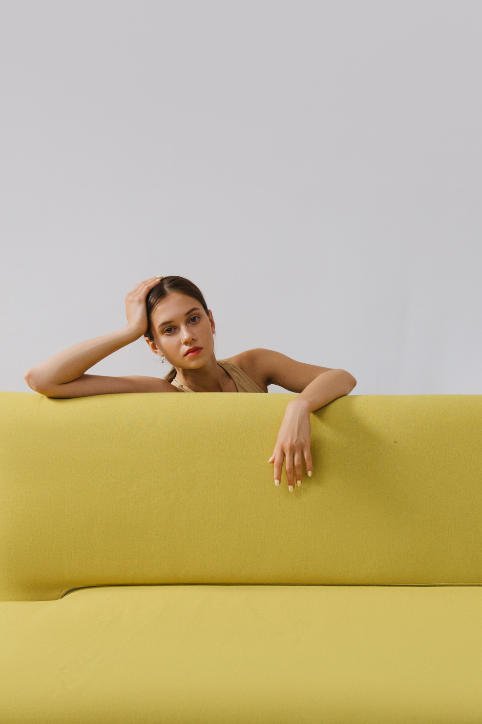 Topless Woman Lying on Yellow Couch