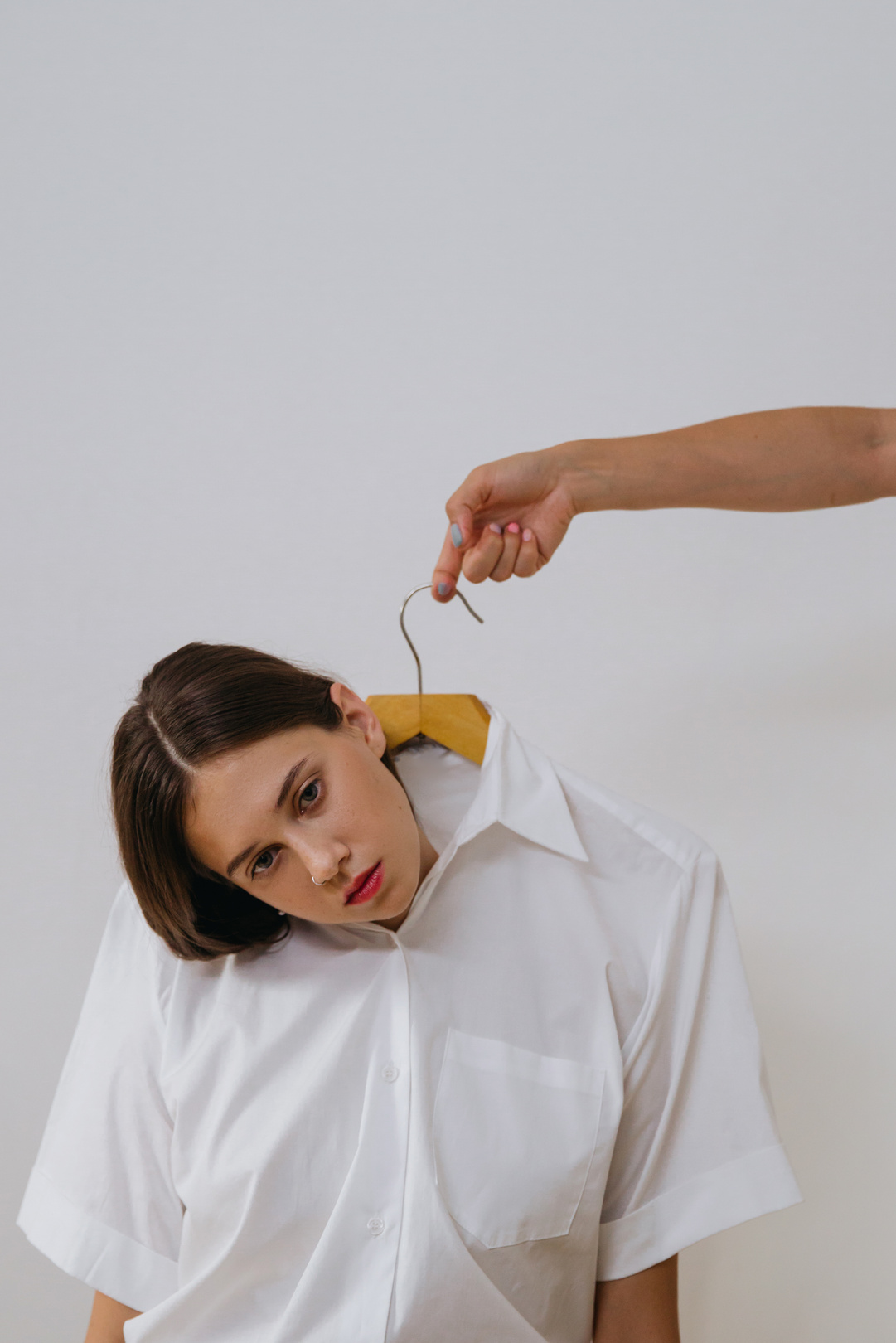 Woman in White Button Up Shirt Holding Yellow String